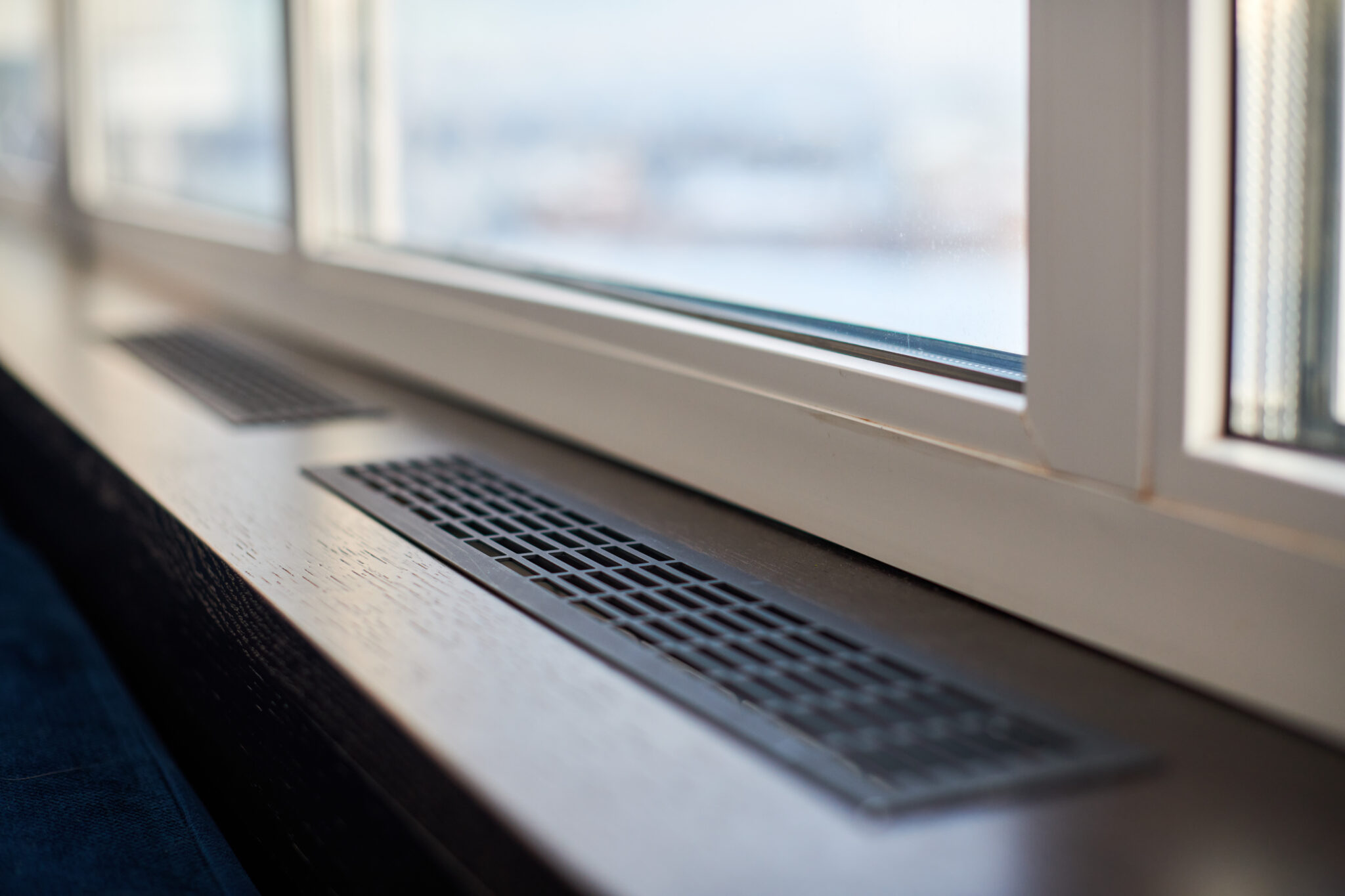 Close-up view of a modern home ventilation grille installed on a windowsill, designed to support energy-efficient airflow and indoor climate control in Maryland homes.