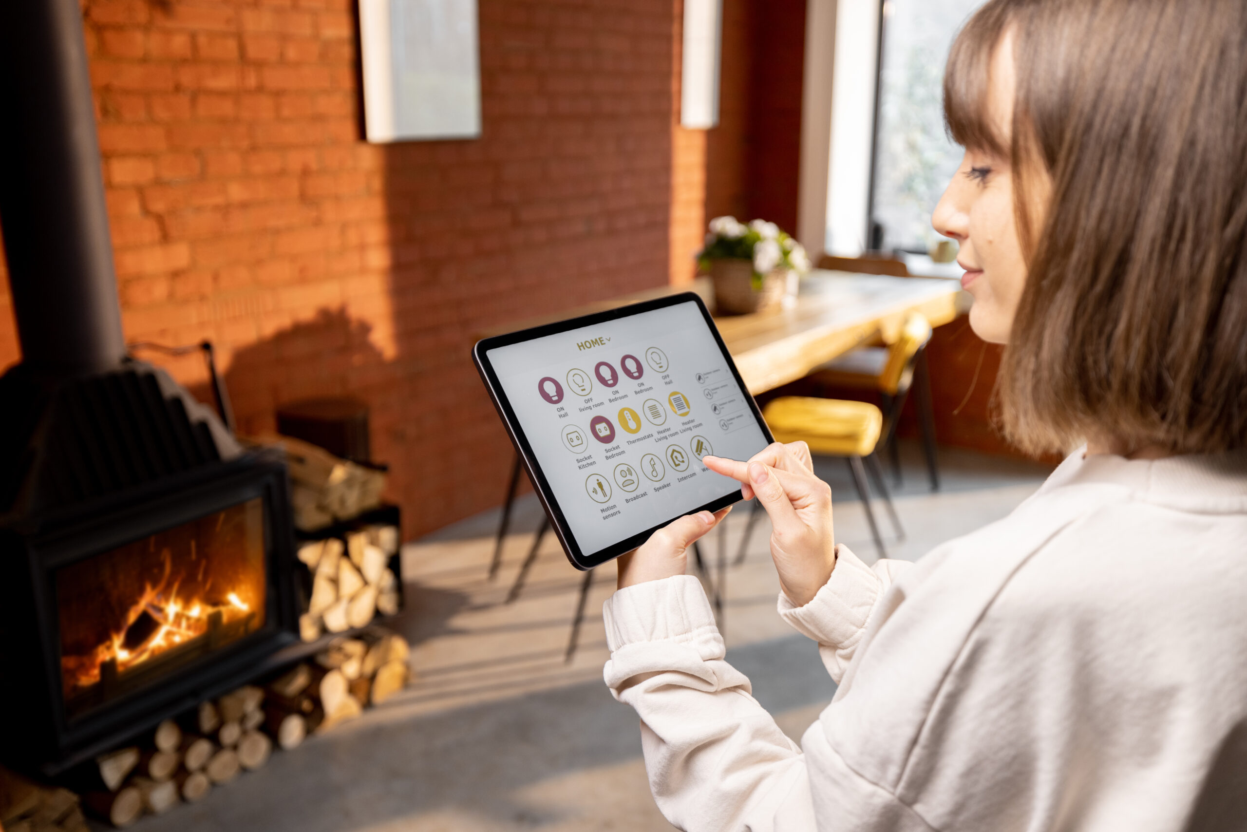 Homeowner using smart home system after an energy audit to control energy usage and improve home performance.