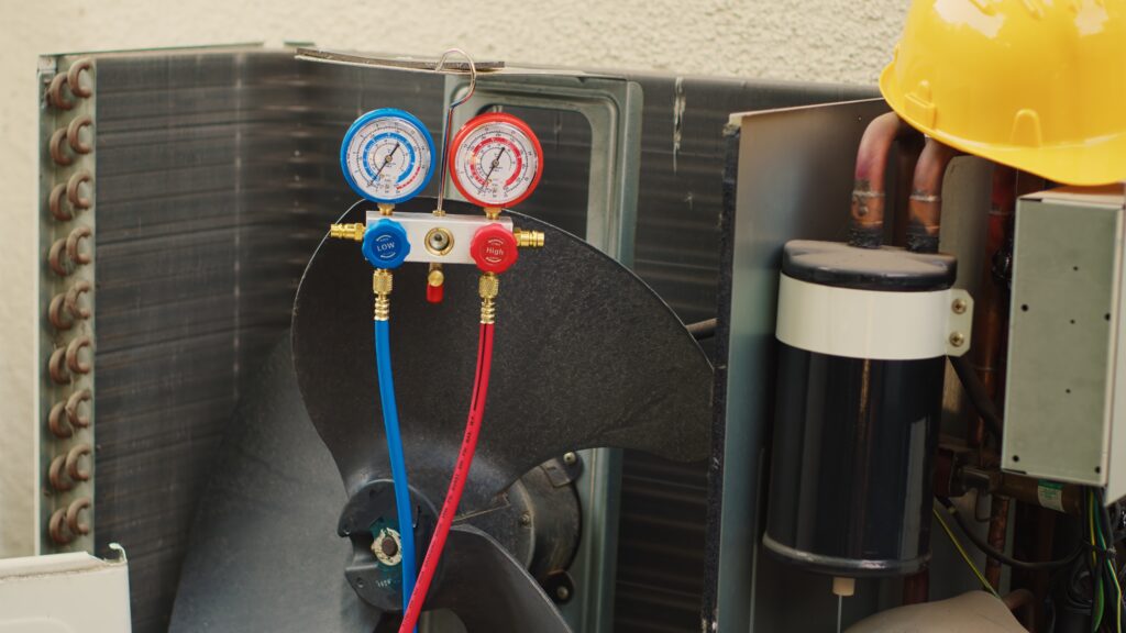 HVAC gauges connected to system components during a diagnostic test to measure pressure and performance.