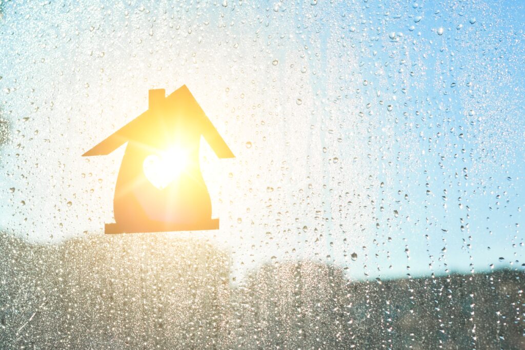 Indoor humidity and condensation visible on a home window during changing weather conditions